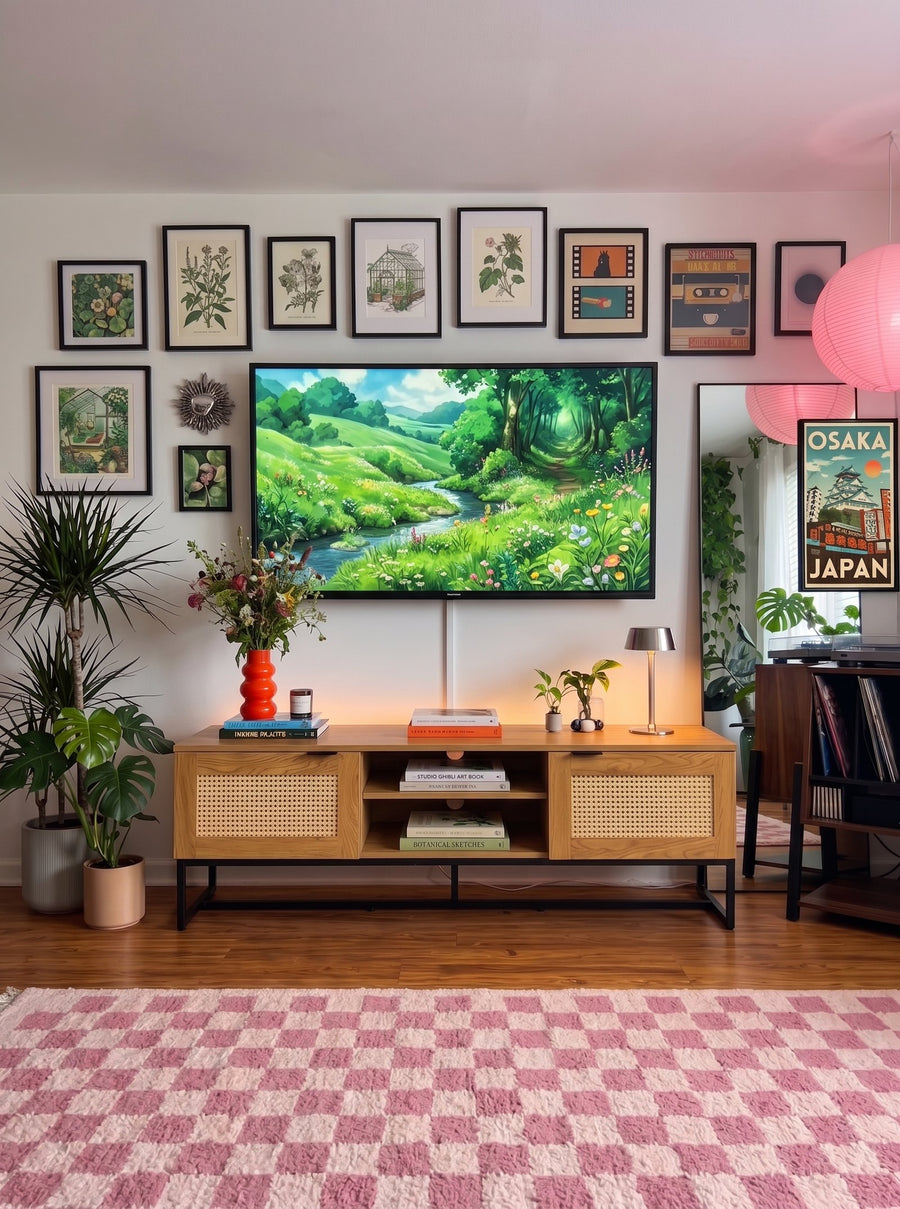Mueble de TV de madera con puertas de rejilla de rattán bajo una pared de cuadros
